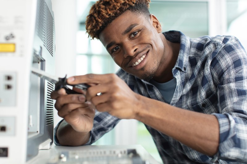 young repairer working with screwdriver in service center